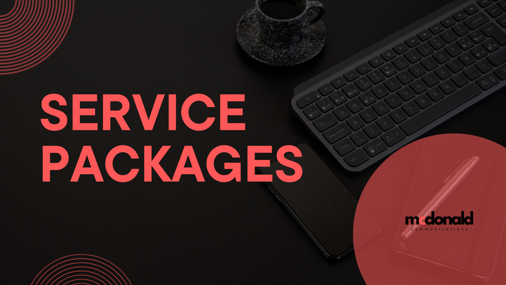 A flat lay image featuring a keyboard, a smartphone, a pen, and a cup of coffee on a dark surface. The words 'SERVICE PACKAGES' are prominently displayed in bold red text, alongside the logo of McDonald Communications.